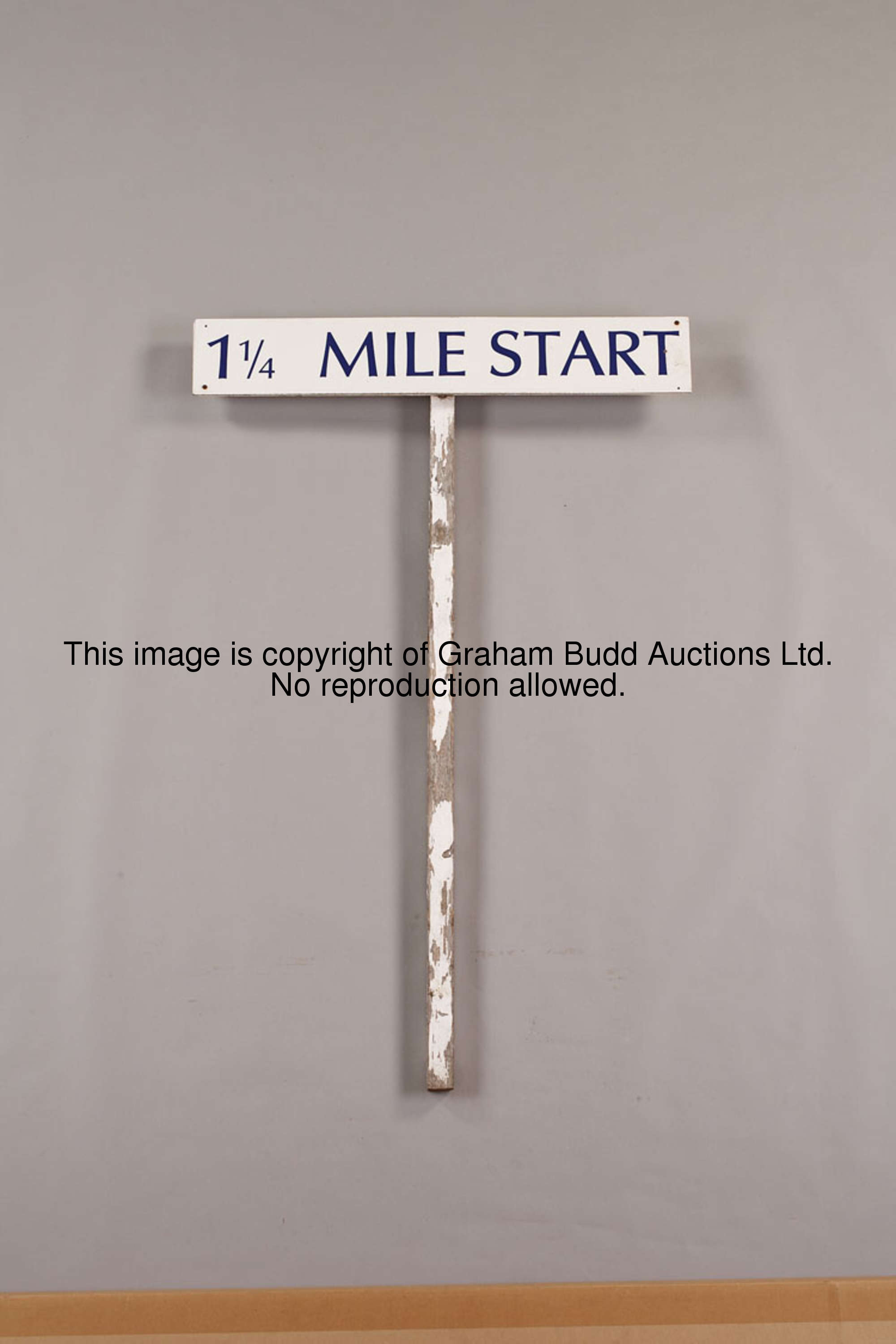 The 1 1/4 Mile racetrack start sign, still mounted on its original wooden pole, white fibreboard wit...