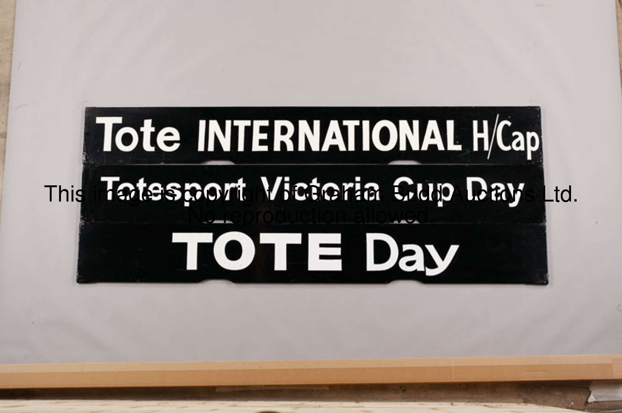 A group of three Tote Spagnoletti boards, reading: TOTE INTERNATIONAL H/CAP; TOTESPORT VICTORIA CUP ...