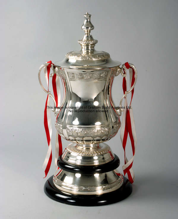 A full-size silver plated replica of the Football Association Challenge Cup Trophy, the two-handled ...