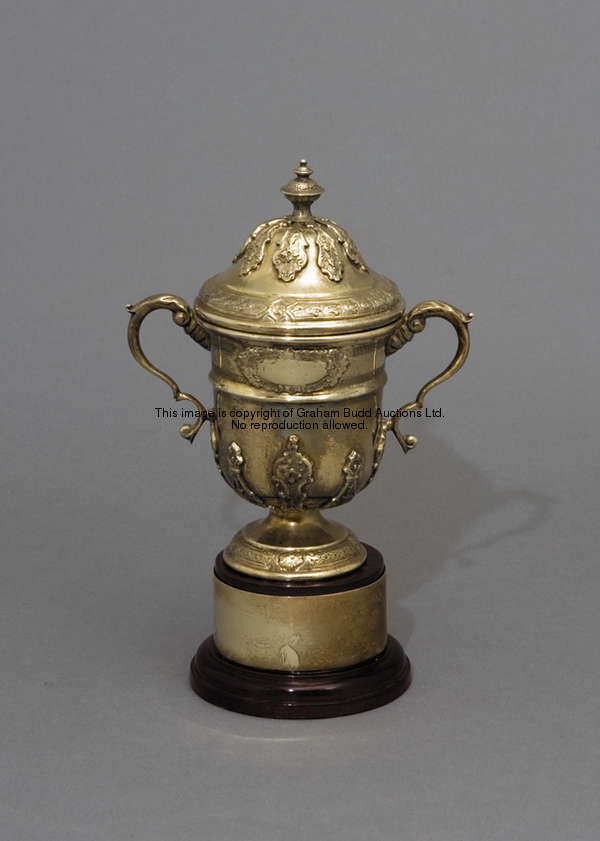 A gilt-metal miniature replica of The Rous Cup, inscribed ROUS CUP, on turned wooden plinth with gil...