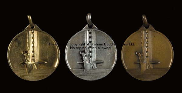 A set of 'gold', silver & bronze medals from the 1930 World Cup in Uruguay, each struck with a view ...