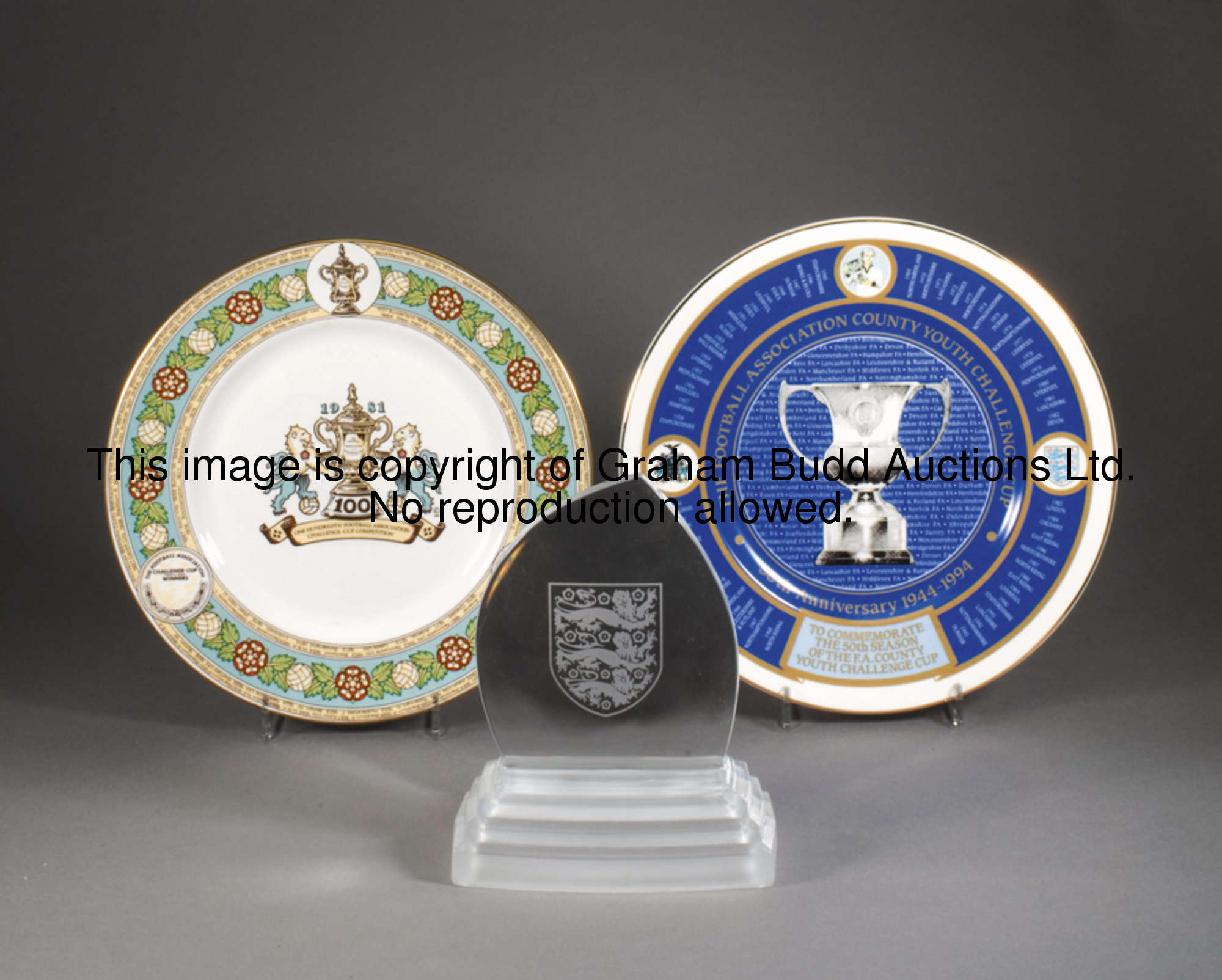 Three Football Association commemoratives, a Royal Doulton crystal plaque etched with the three lion...