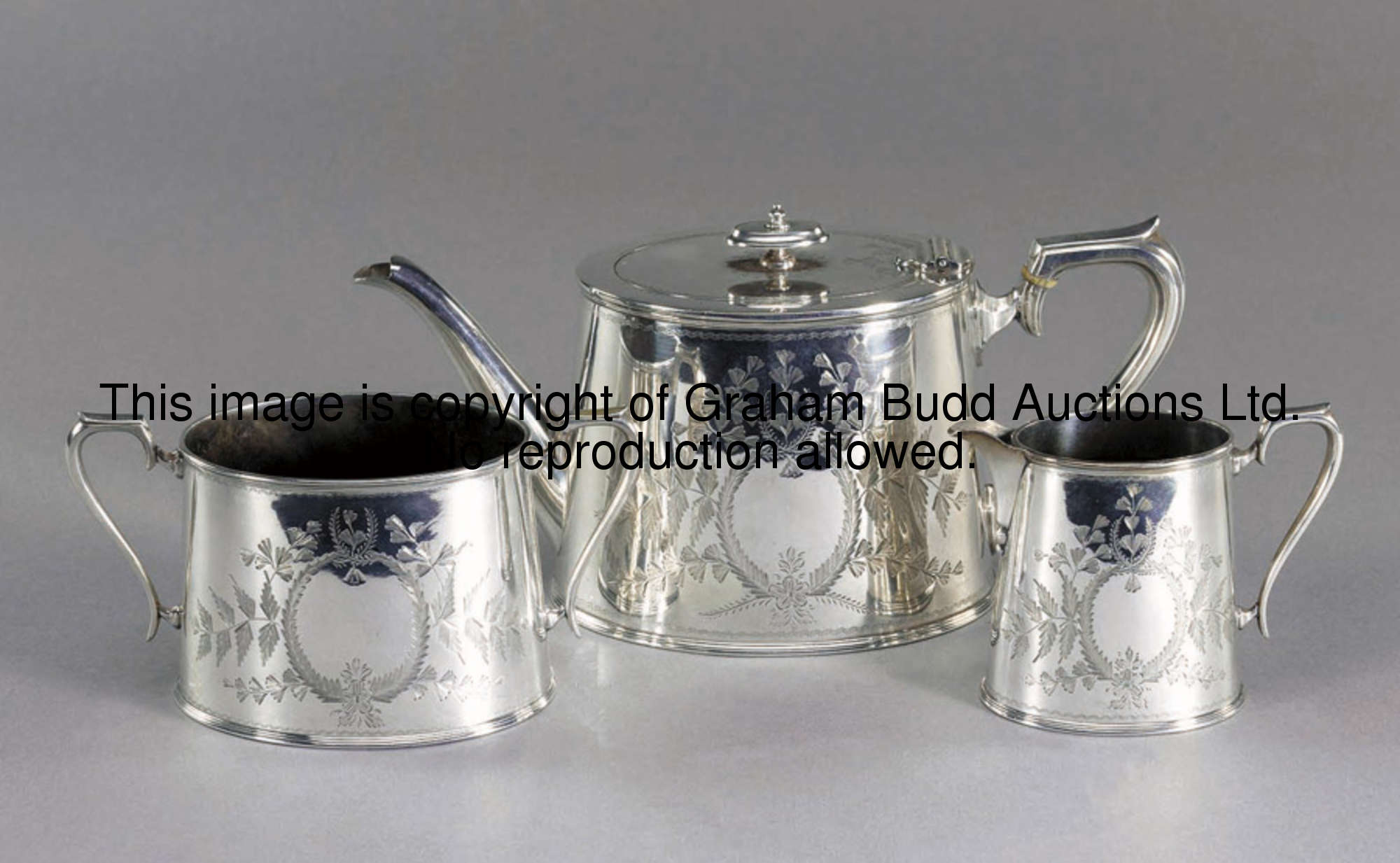 A three-piece electroplated tea service presented to Crystal Palace FC, the teapot inscribed PRESENT...