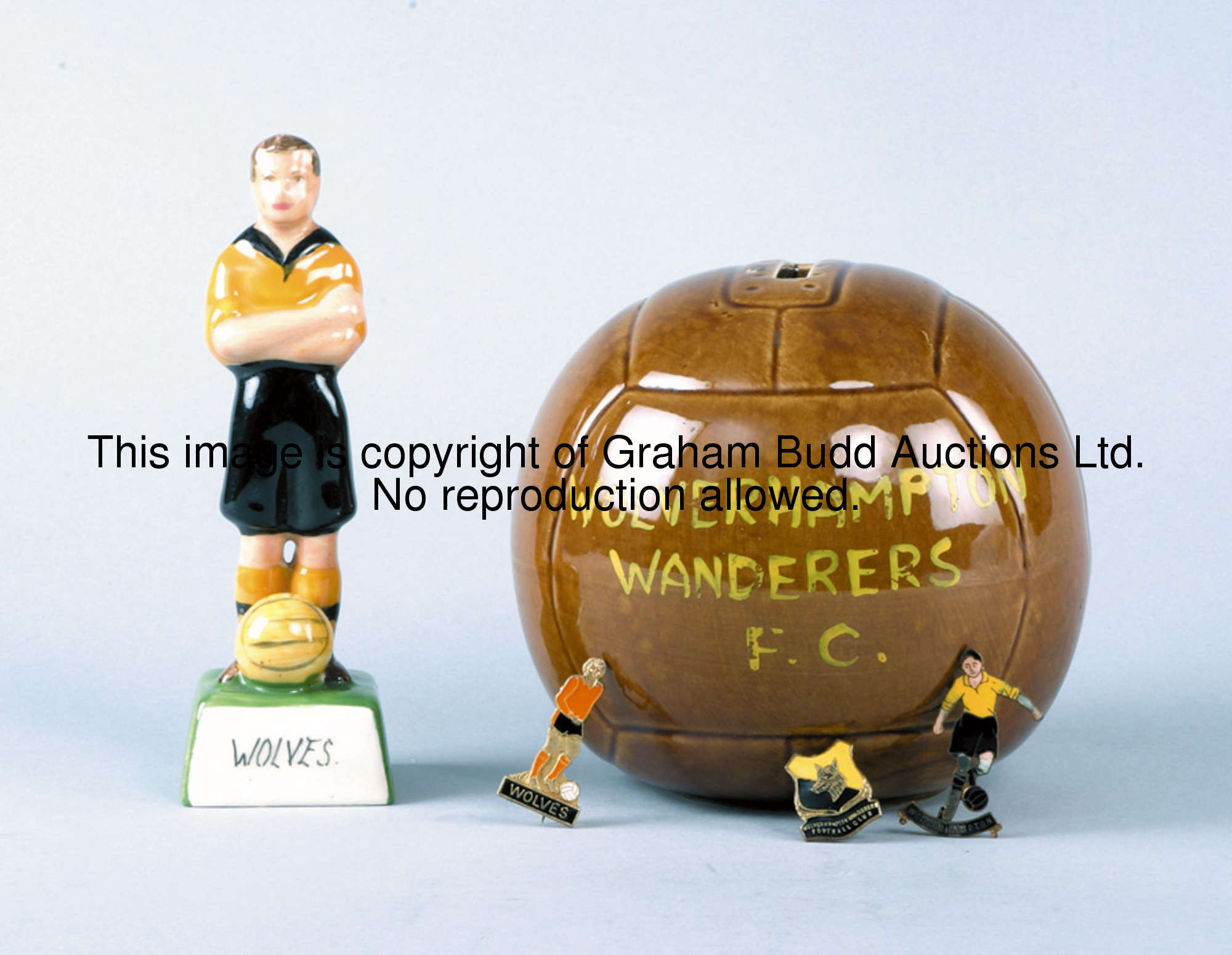 Wolverhampton Wanderers memorabilia, comprising a pottery money box in the form of a brown glazed pa...