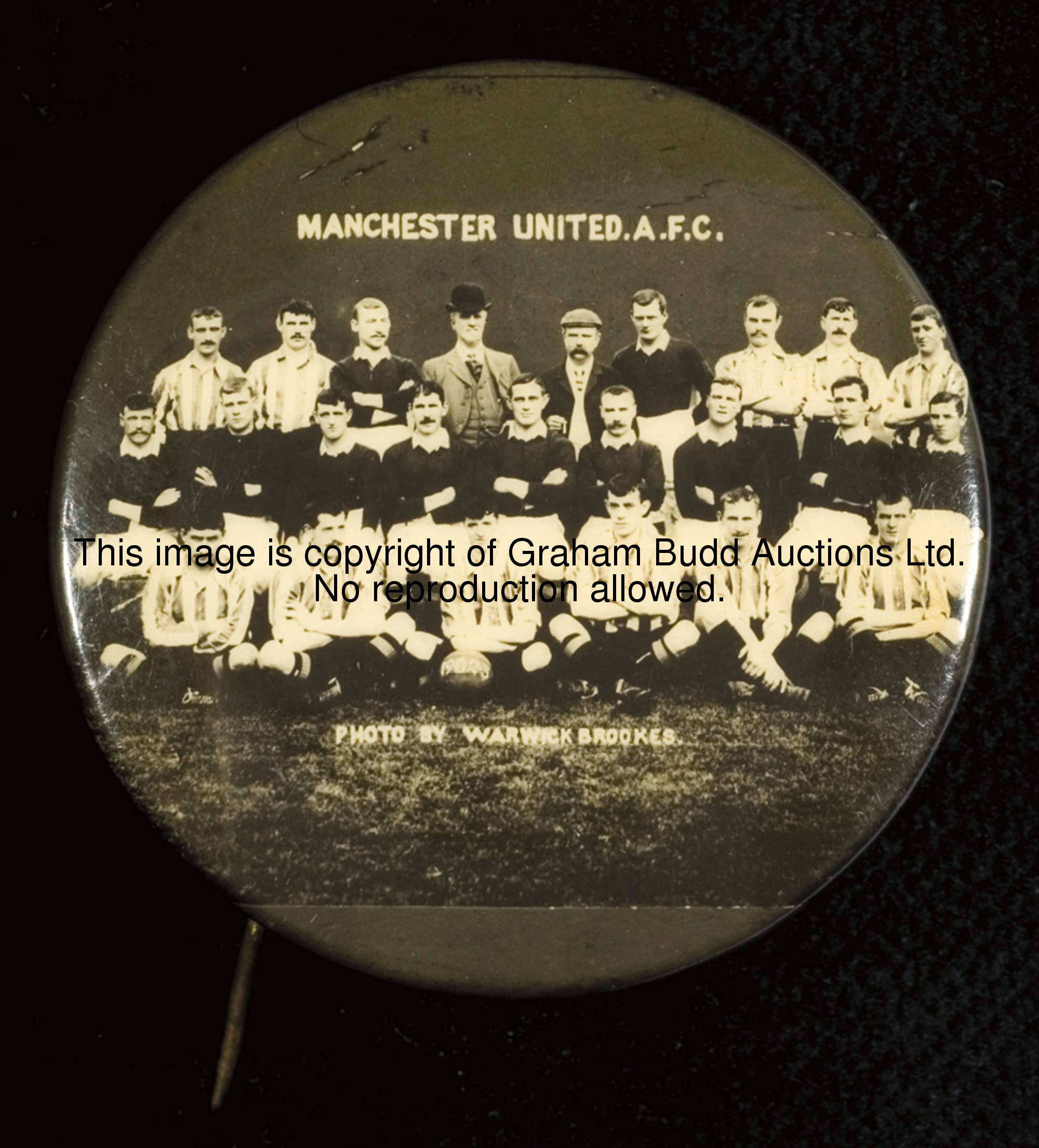 A rare and early Manchester United pin badge with a photographic team-group portrait of the 1902-03 ...