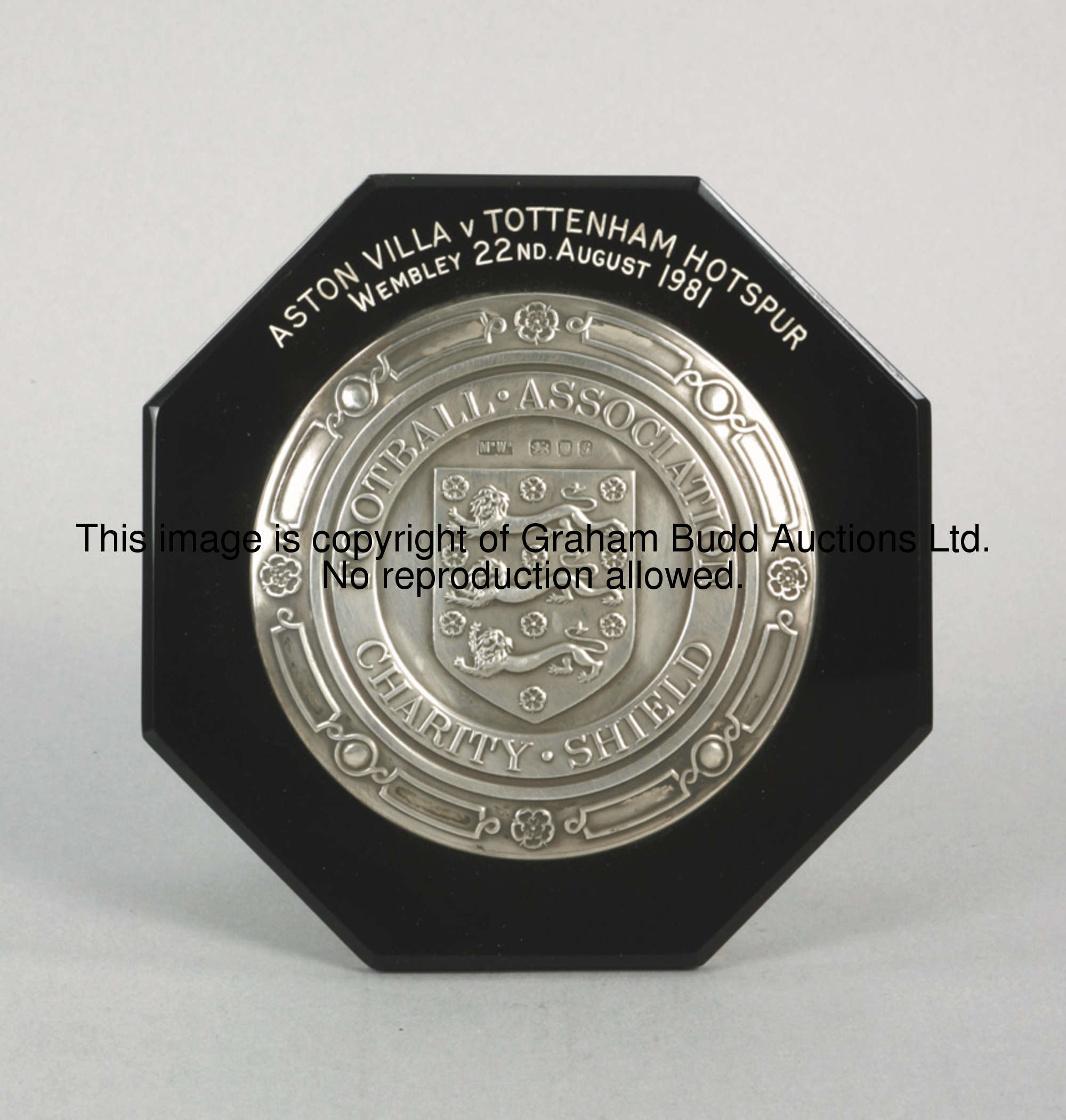 A silver miniature of the F.A. Charity Shield, inscribed FOOTBALL ASSOCIATION CHARITY SHIELD, set on...