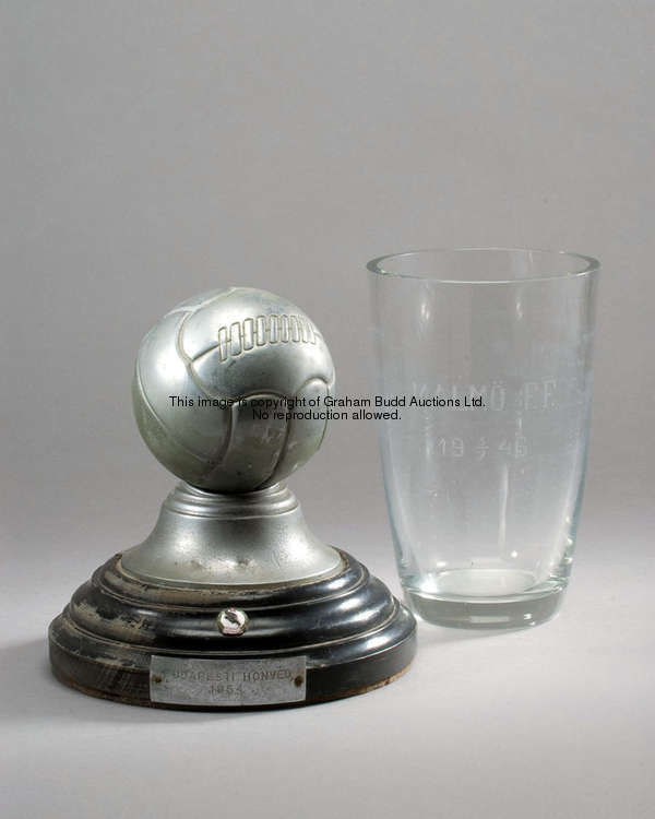 Two Wolverhampton Wanderers match presentations, a metallic model of a football set on a stepped ebo...