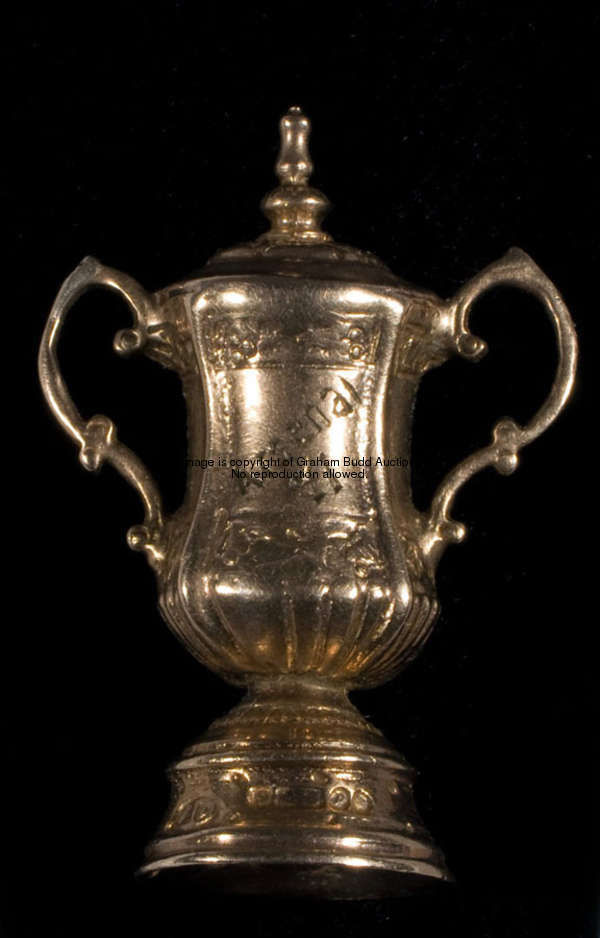 A 9ct. gold miniature model of the F.A. Cup, inscribed, THE F.A. CUP, ARSENAL, 71, height 2.8cm., 1 ...