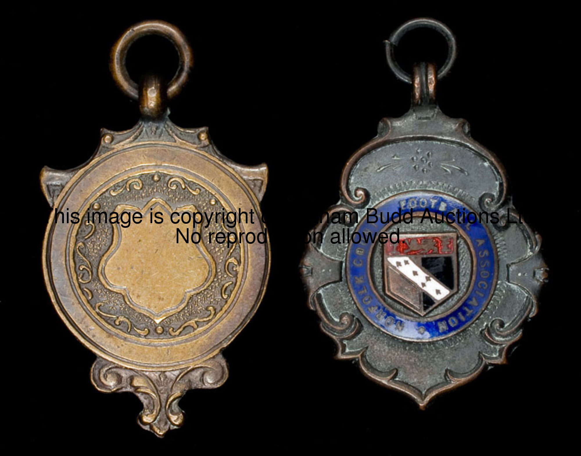 Two junior football medals won by Maurice Norman, the first in silver and inscribed W.D.S.S., 1948-4...