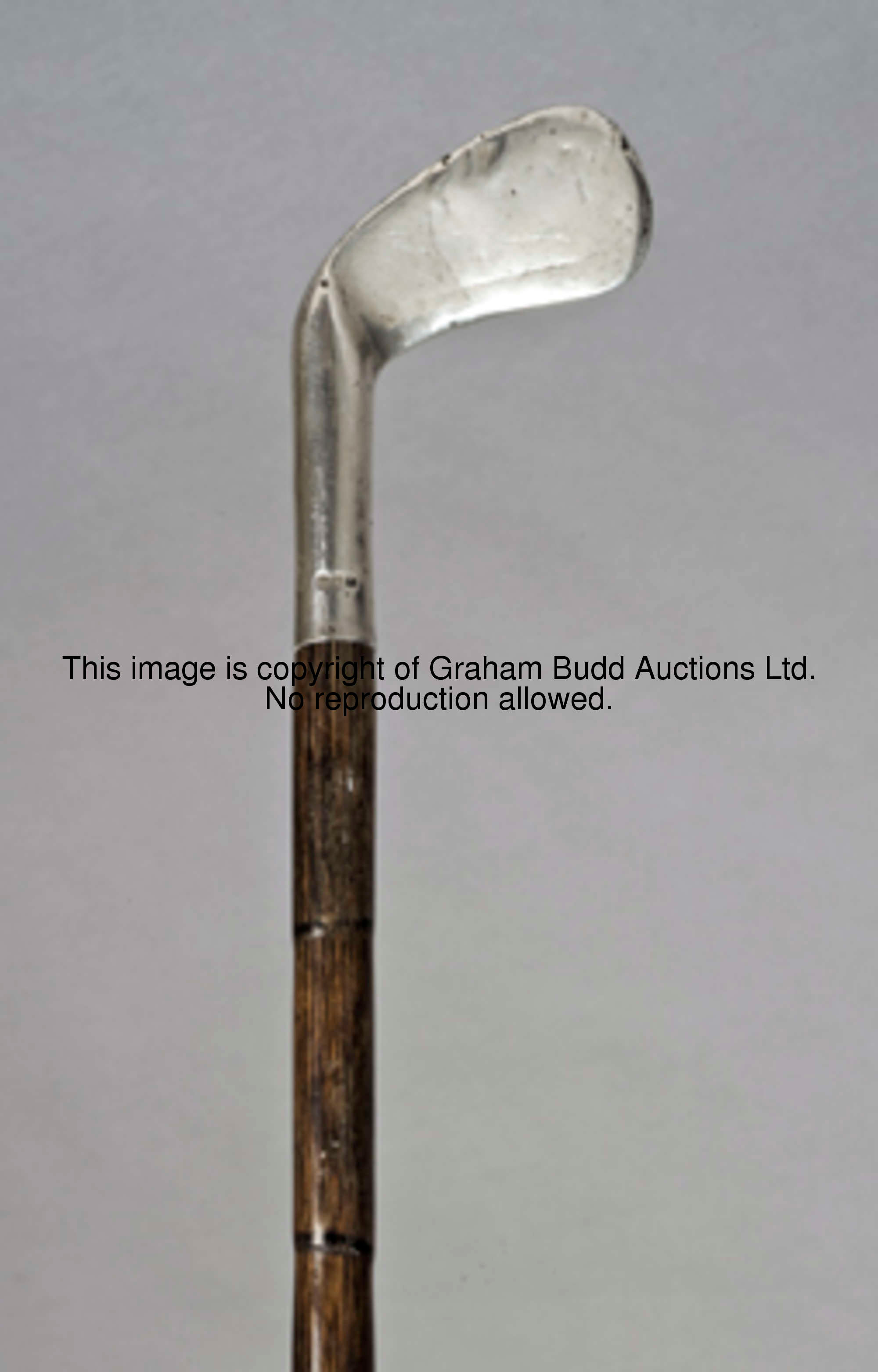 A Sunday golf walking cane fitted with a silver clubhead handle, the silver hallmarked London, maker...