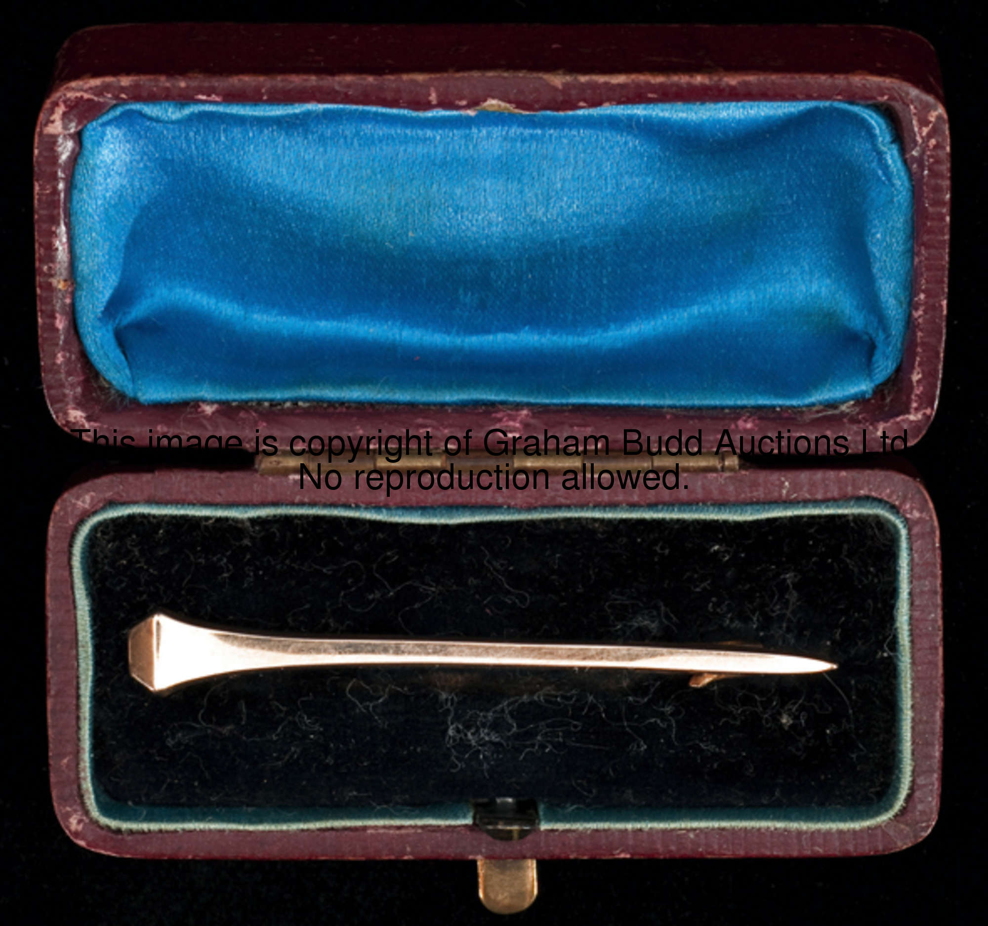 A 9ct. gold brooch designed as a horse shoe nail, in original fitted case