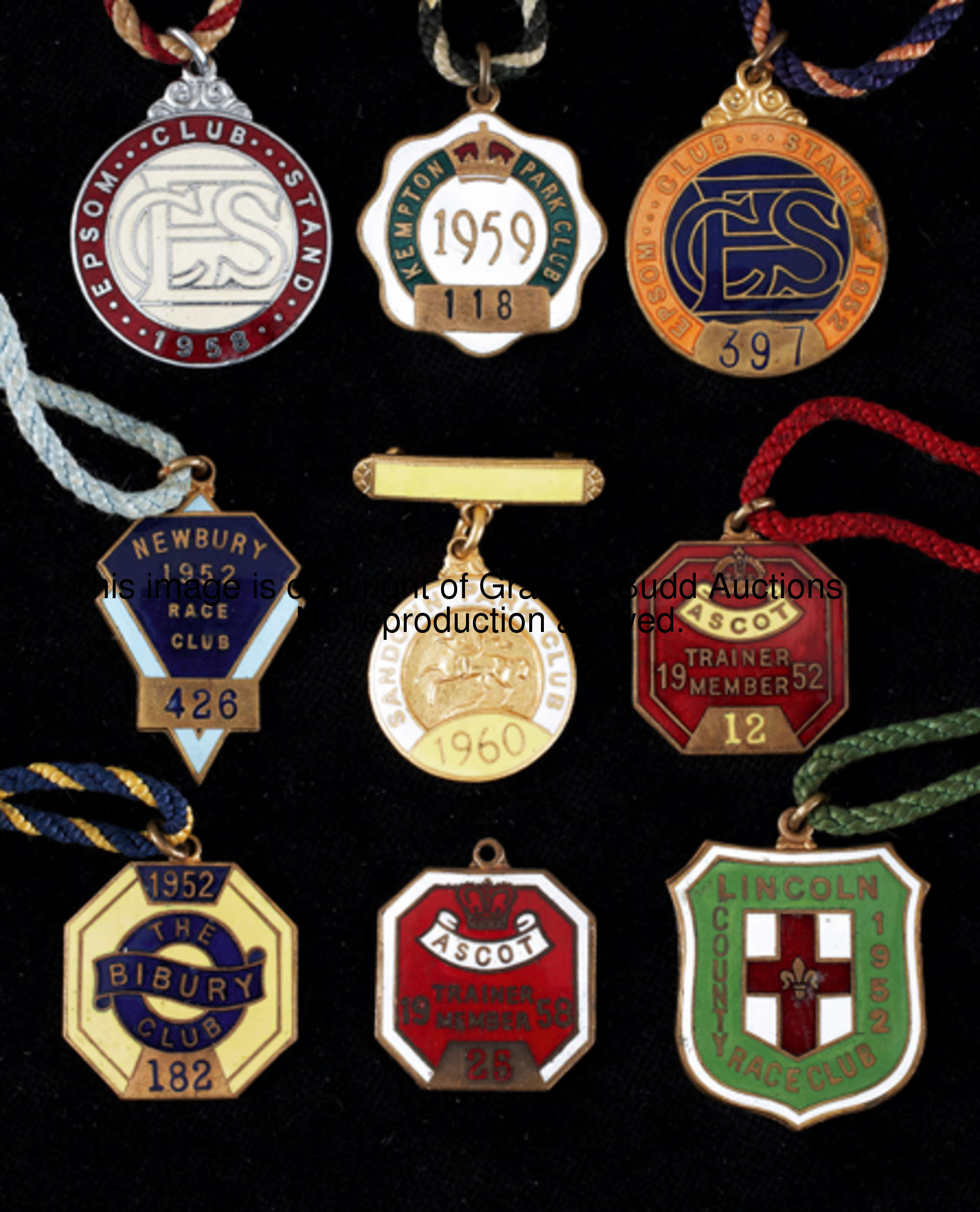 A collection of 26 gilt-metal and enamel racing members' badges, for: Ascot 1952 (trainer), 1966; Bi...