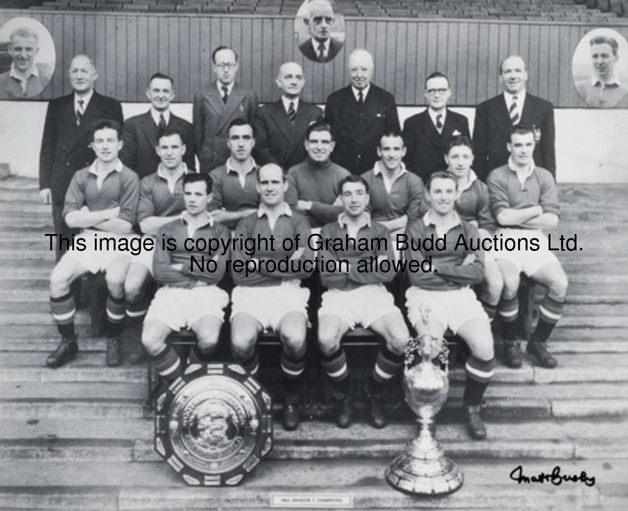A signed b&w photograph of the Manchester United 1952 Championship winning team signed by Matt Busby...