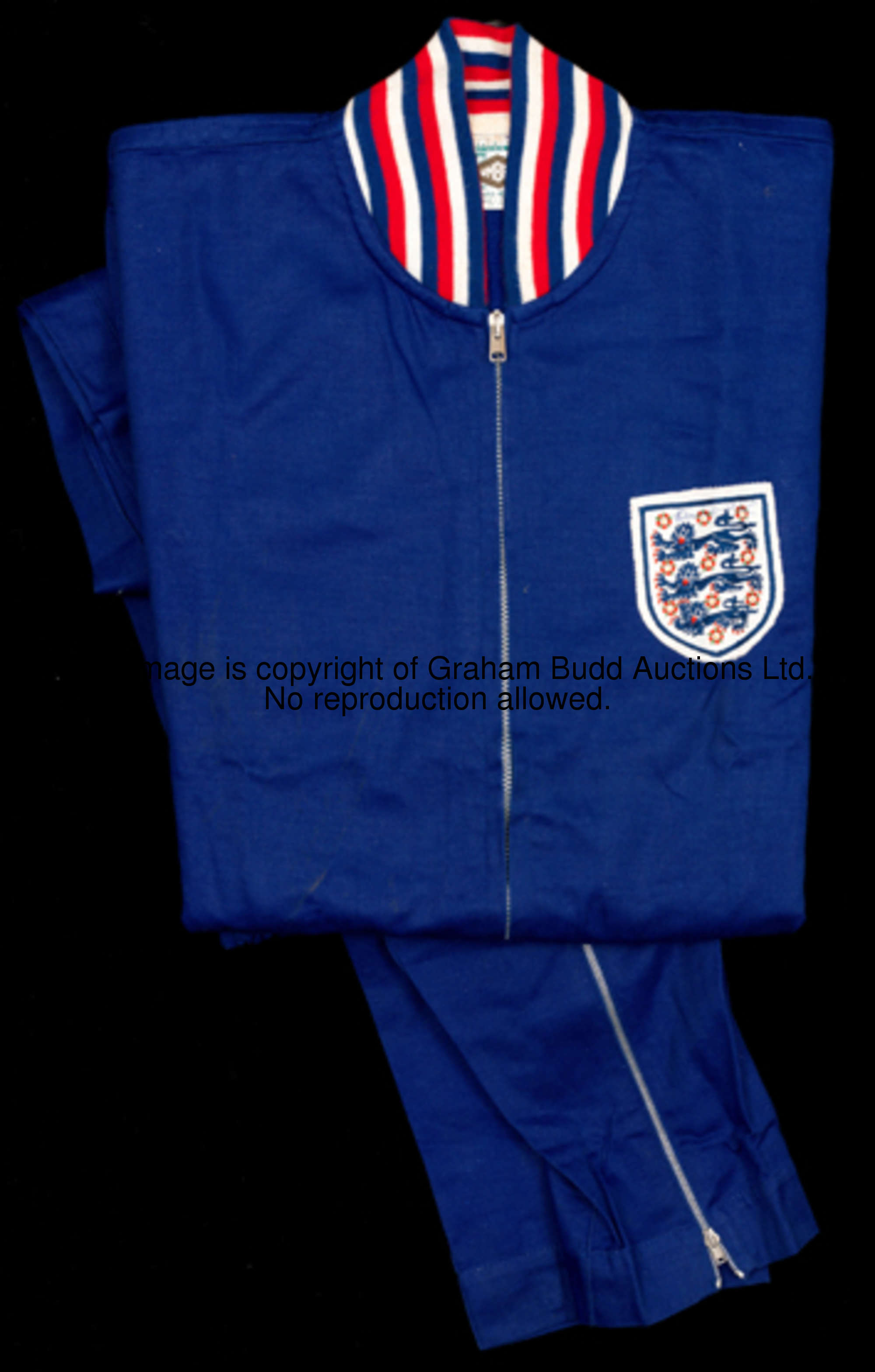 A signed Bobby Moore England training suit, signed by Bobby Moore on the three lions badge, a blue U...