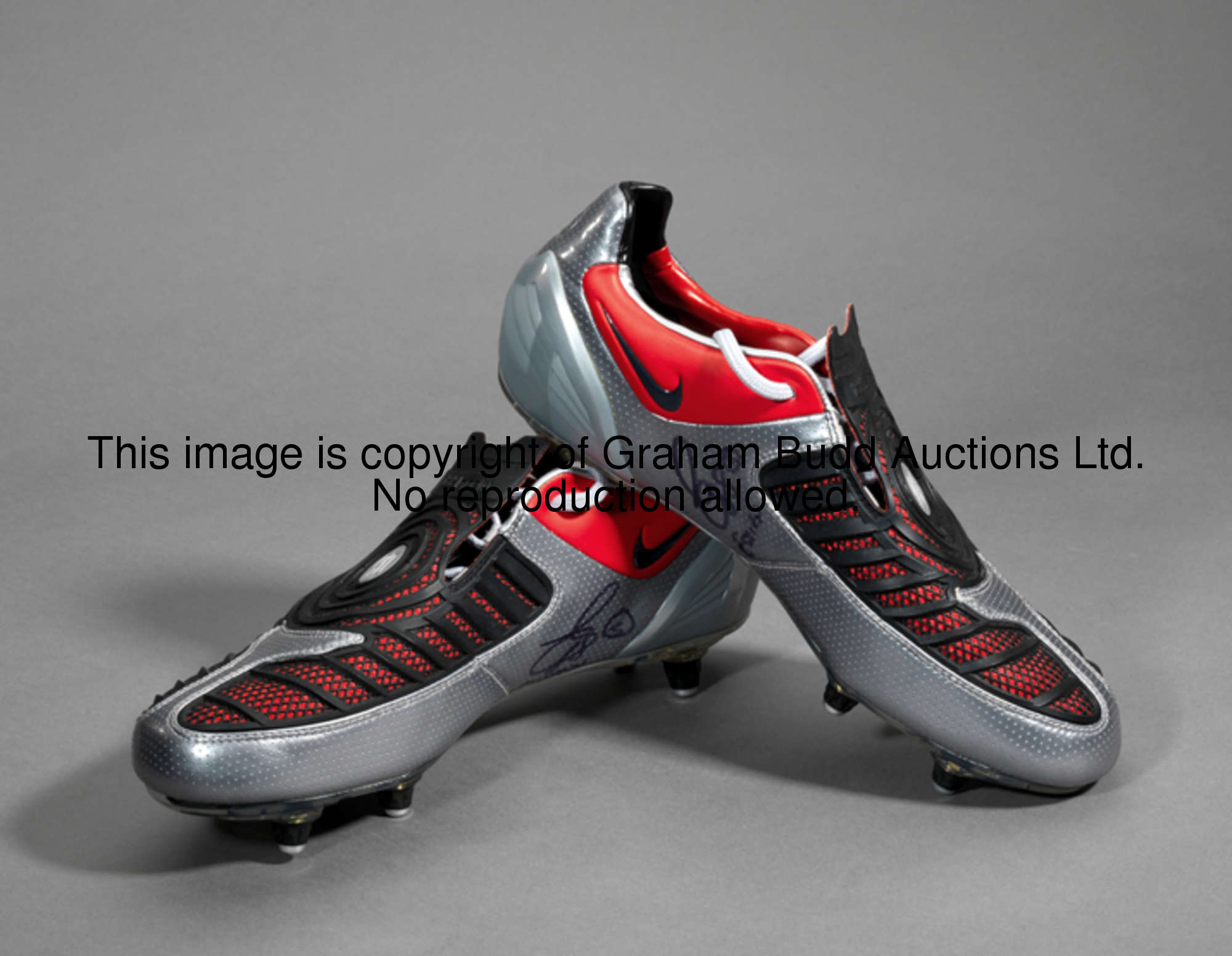 Michael Essien: a signed pair of football boots, silver, black & red Nike Total Ninety boots inscrib...