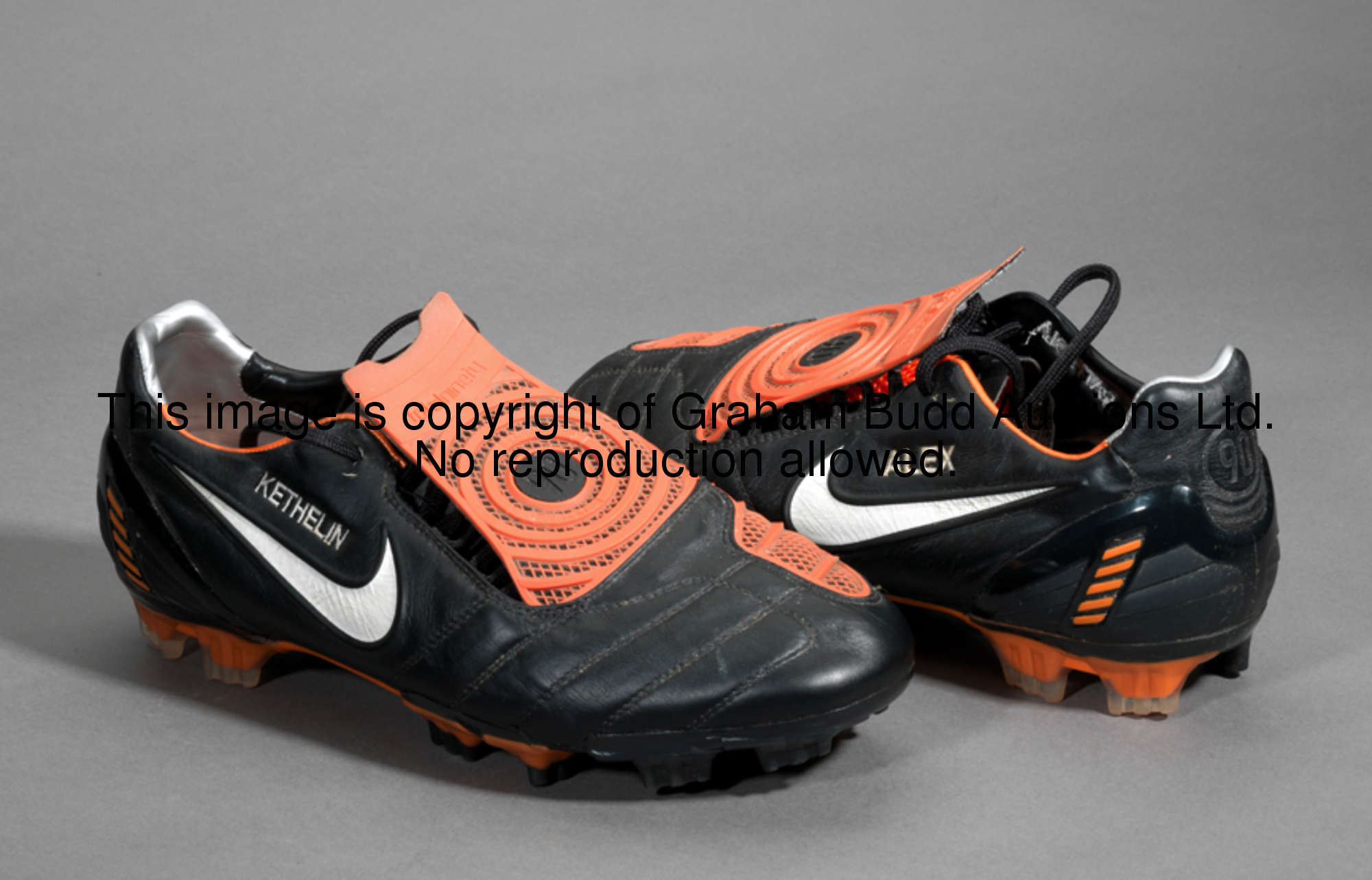 Alex: a pair of football boots, black & orange Nike Total Ninety boots, the left boot inscribed ALEX...