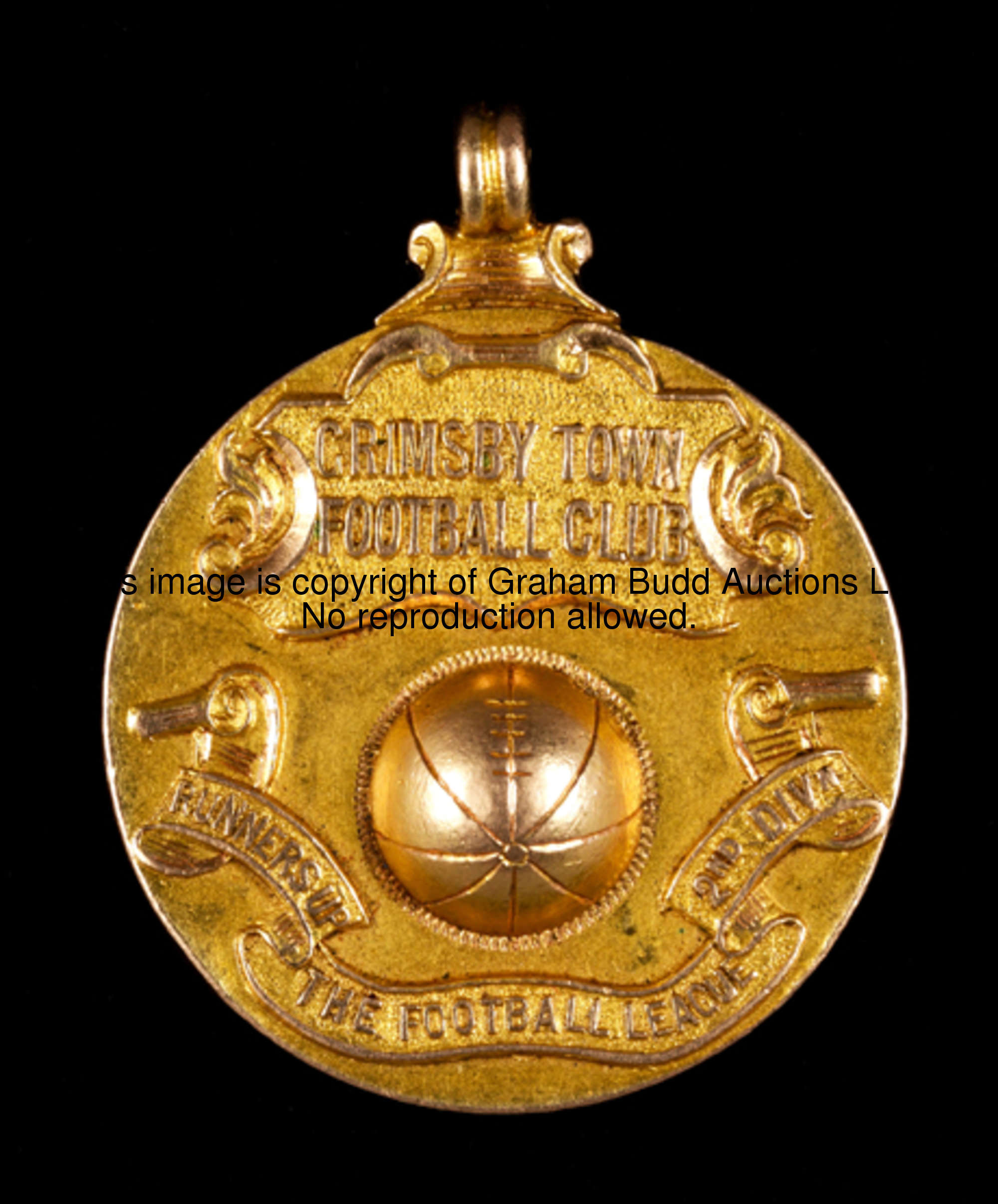A 15ct. gold medal commemorating Grimsby Town's promotion to the First