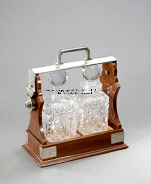 A mahogany tantalus case with two crystal decanters, a wedding gift to Keith & Iris Piggott in 1929,...