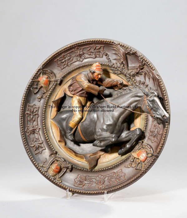 A painted terracotta wall charger featuring a steeplechaser & jockey in high relief, the border with...