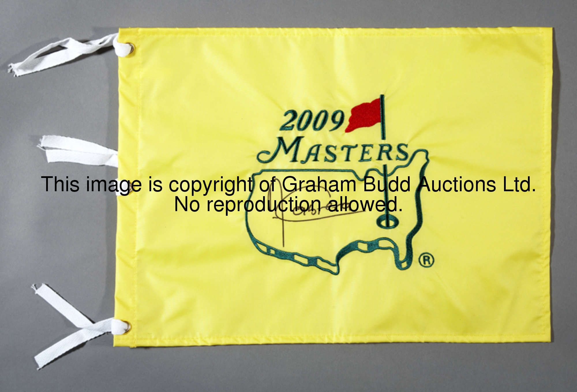 A 2009 Masters golf pin flag signed by the winner Angel Cabrera, signature in black marker pen 