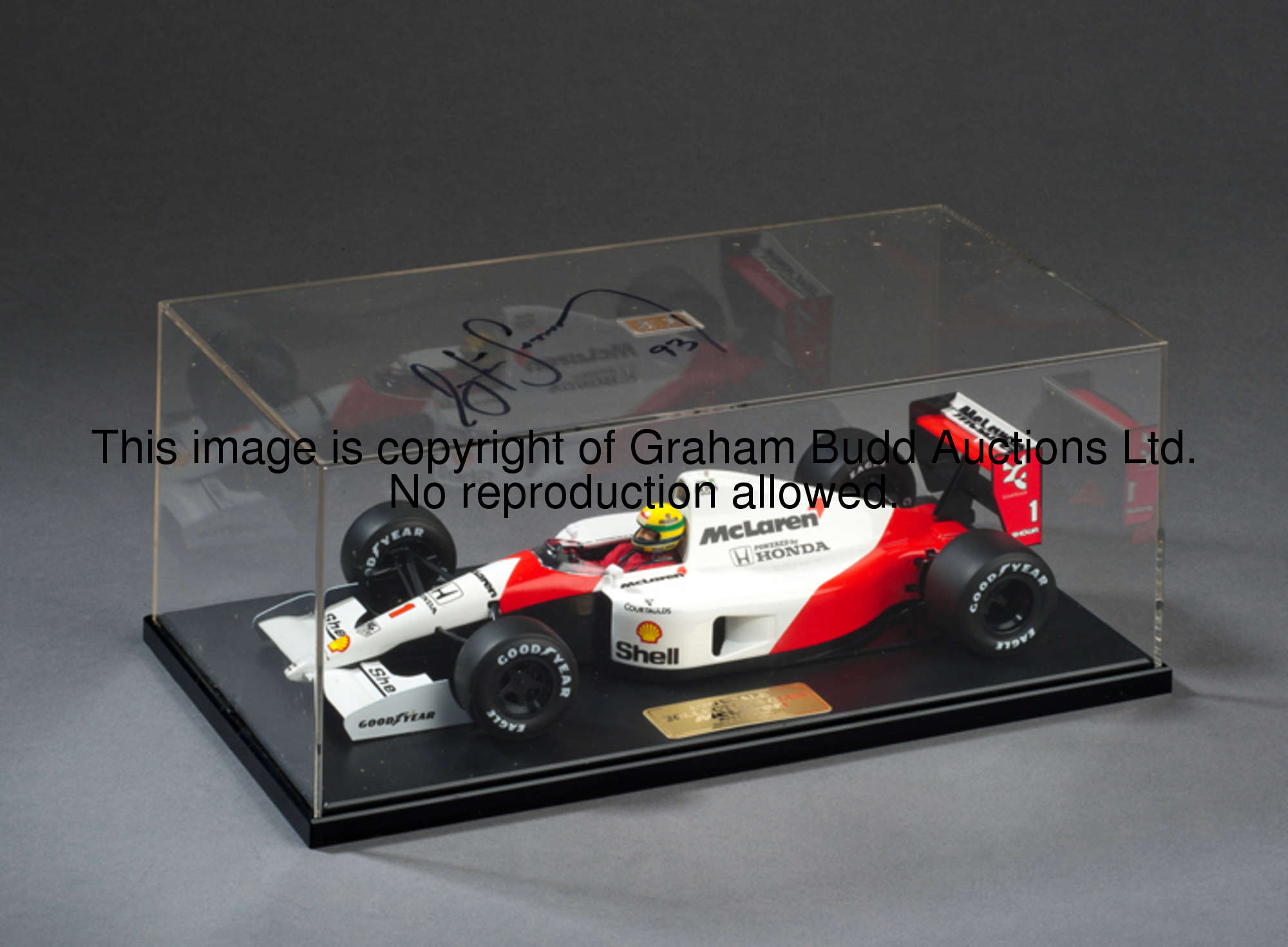 Ayrton Senna-signed 1:20 scale Tamiya model McLaren-Honda MP4-6,  the top of its plexi-glass case be...