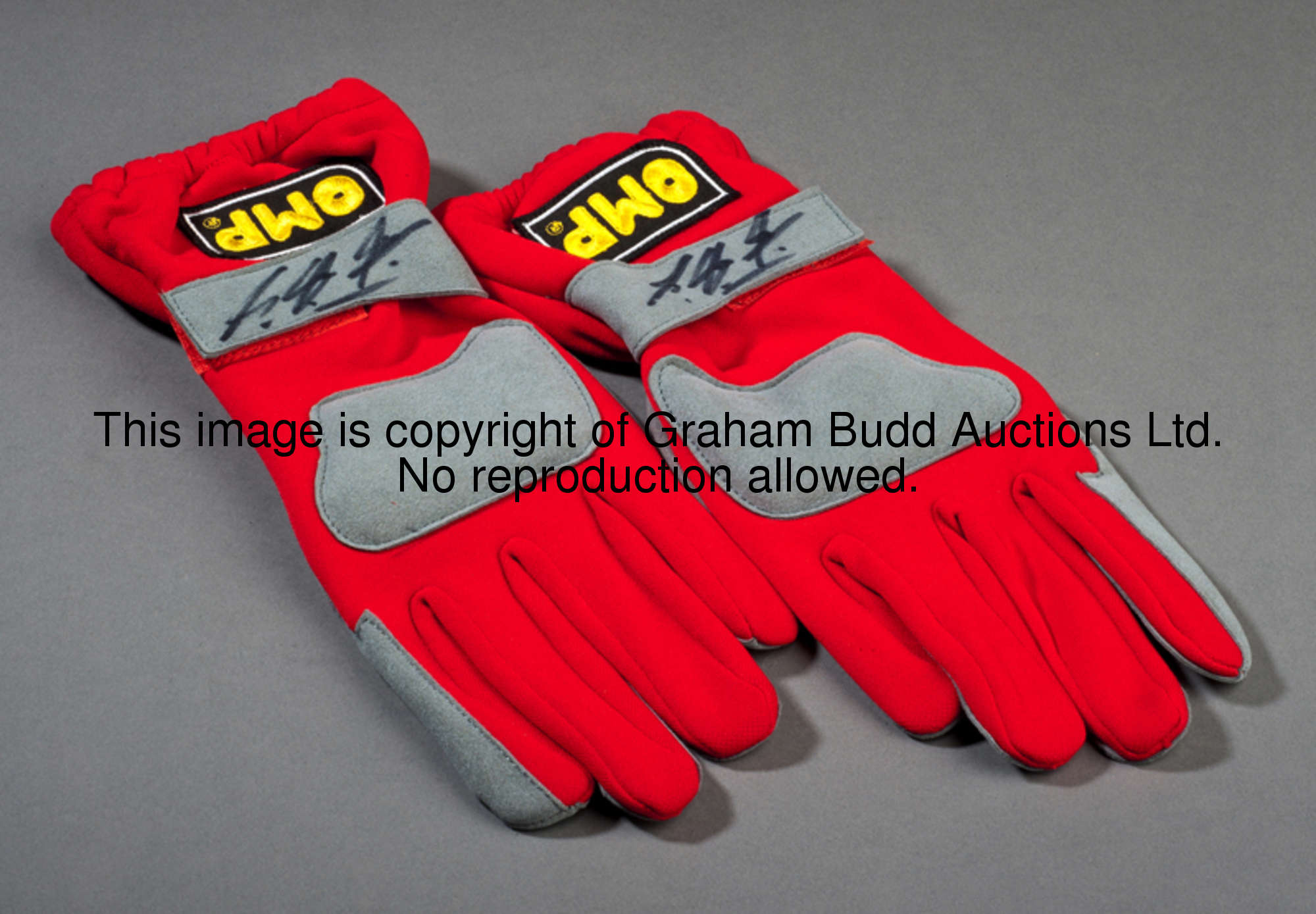 Michael Schumacher-signed driving gloves,  each synthetic leather wrist-strap bearing his marker pen...