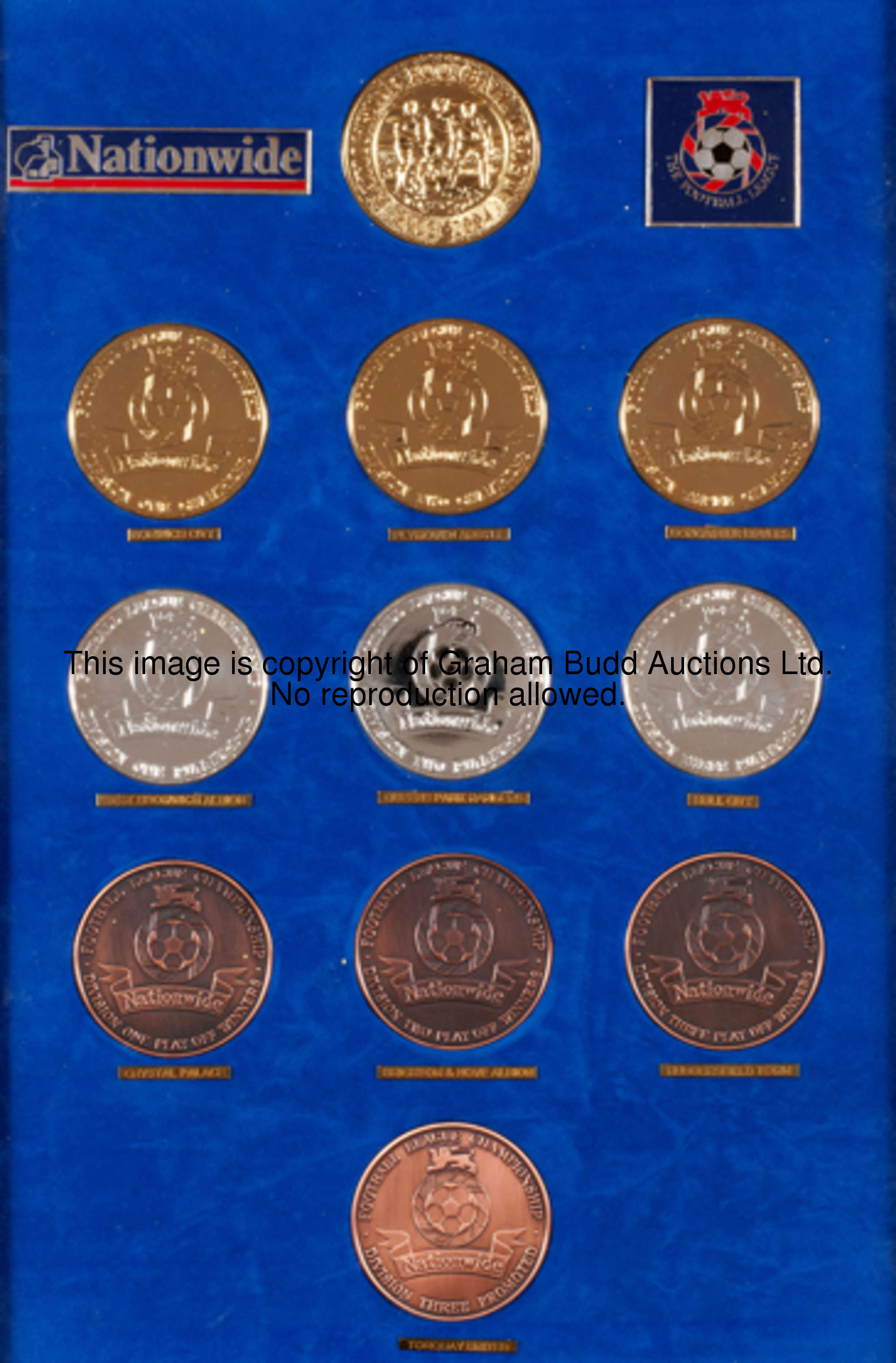 A display set of Nationwide Football League medals struck for the 2003-04 season, with 'gold', 'silv...