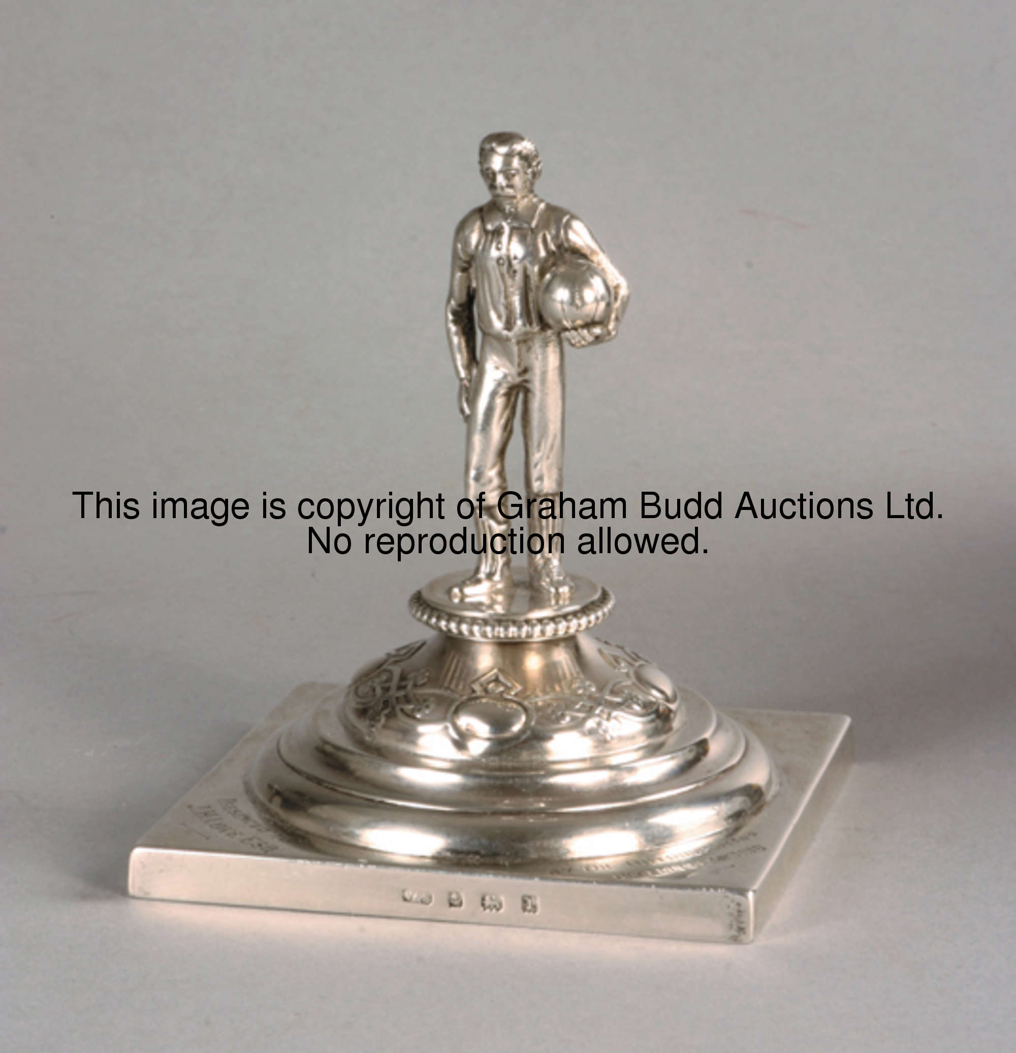 A silver figure of a footballer, hallmarked Birmingham, 1910, modelled as a standing footballer dres...