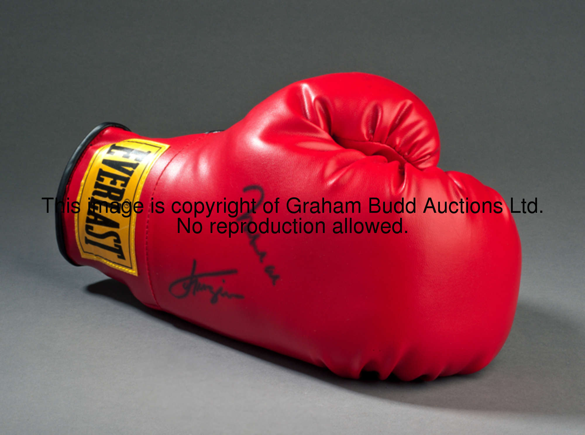 A boxing glove double-signed by Muhammad Ali and Joe Frazier, a left-hand red Everlast, signatures i...