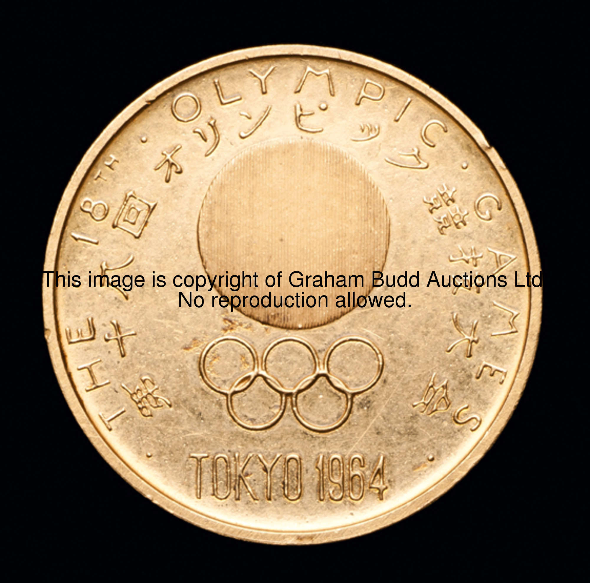A gold medal commemorating the 1964 Tokyo Olympic Games, stamped .900, designed by Yusaku Kamekura (...