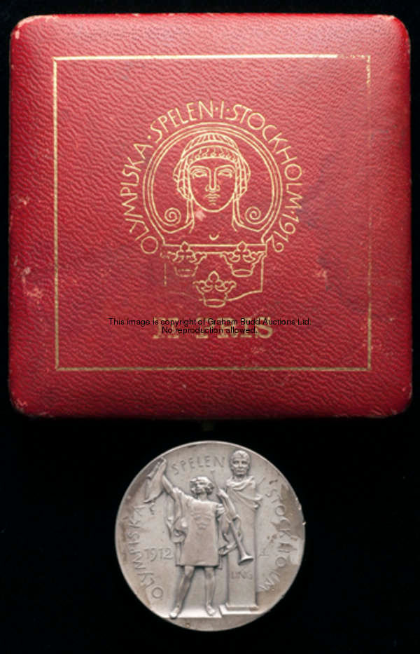 A 1912 Stockholm Olympic Games cased silver prize medal, designed by Erik Lindberg & Bertram Mackenn...