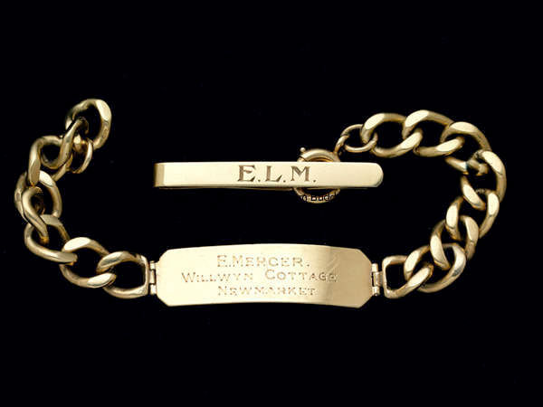 A 9ct. gold bracelet and tie clip formerly owned by the jockey Manny Mercer, the bracelet engraved E...