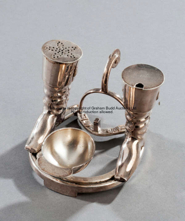 An electroplated novelty cruet set, the base a horse shoe, the pepper and mustard pots riding boots,...