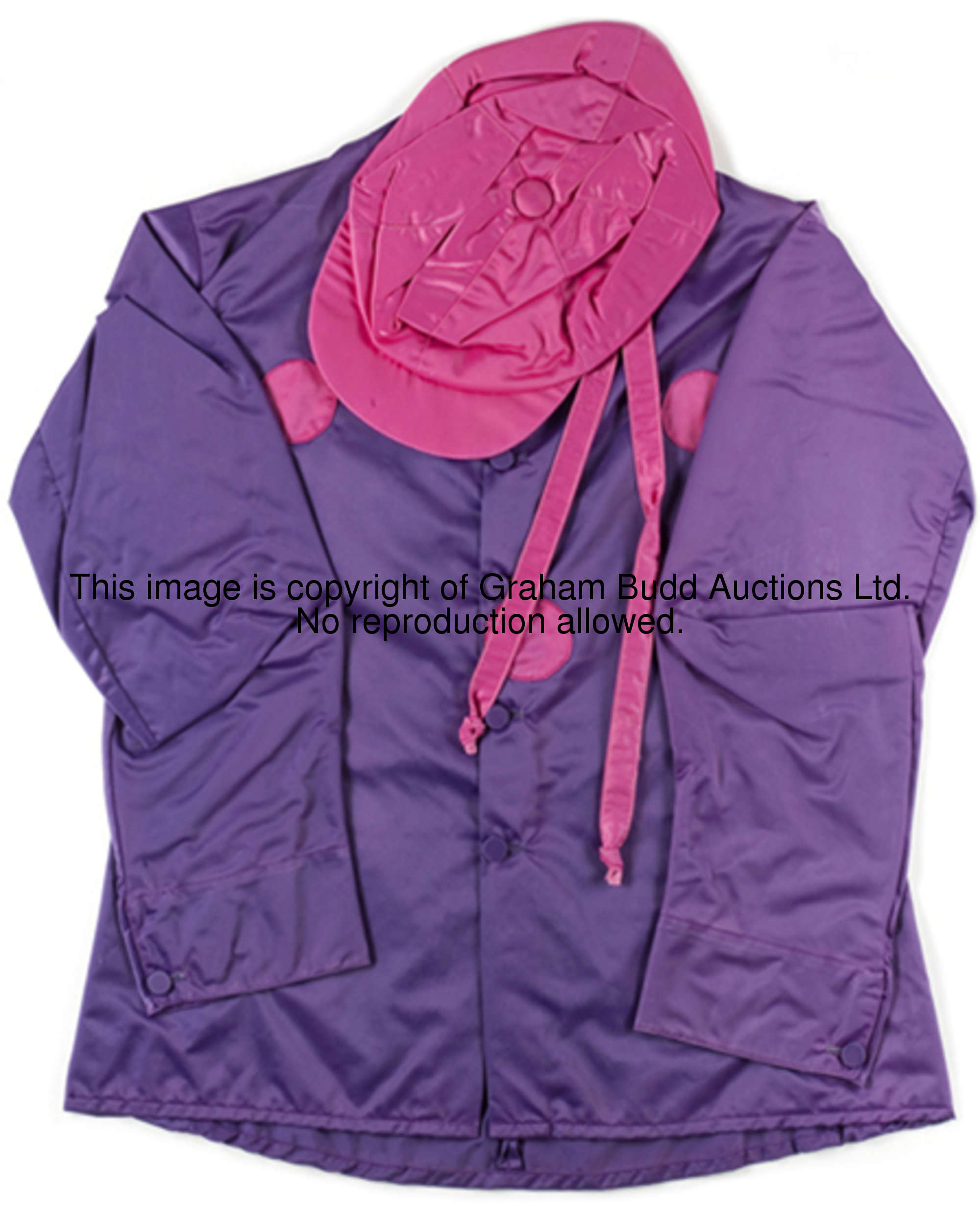 A set of Brigadier Gerard silks, a violet jacket with cerise spots to body, cerise cap, mounted, fra...