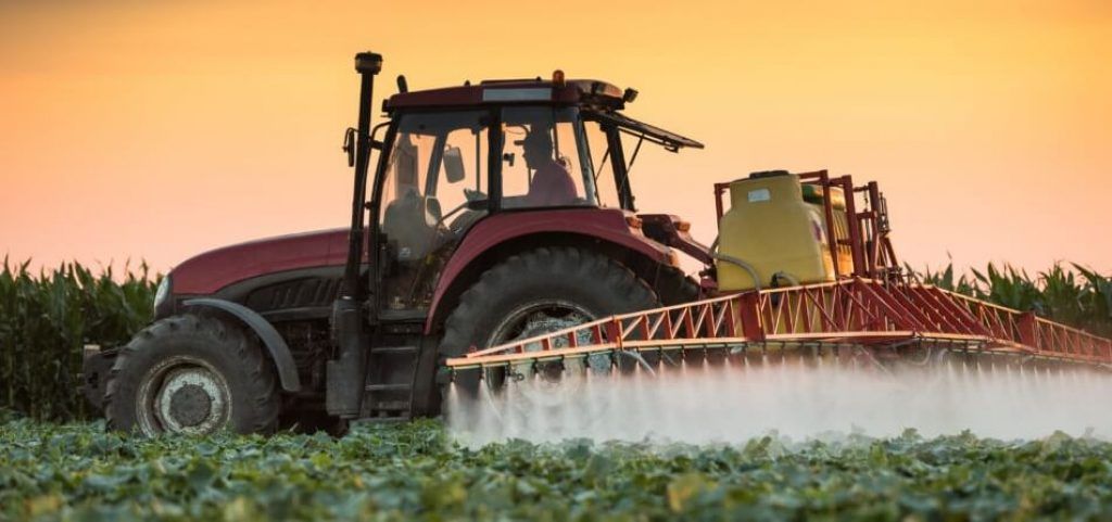 Farmer applying pesticides to crops