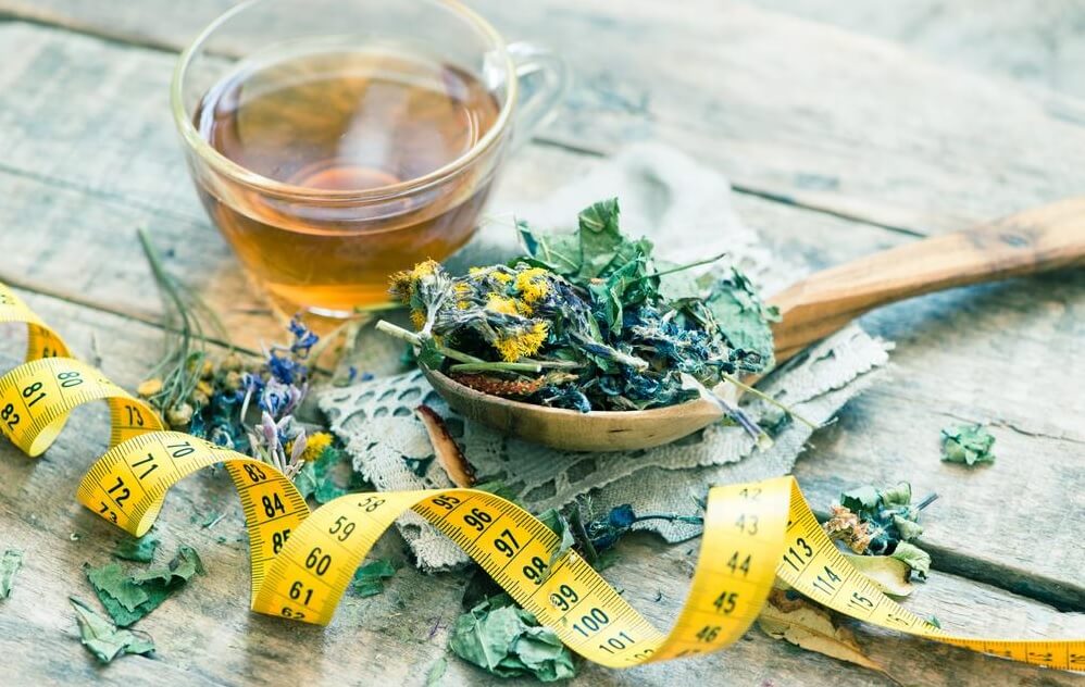 Detox tea leaves alongside cup of brewed tea