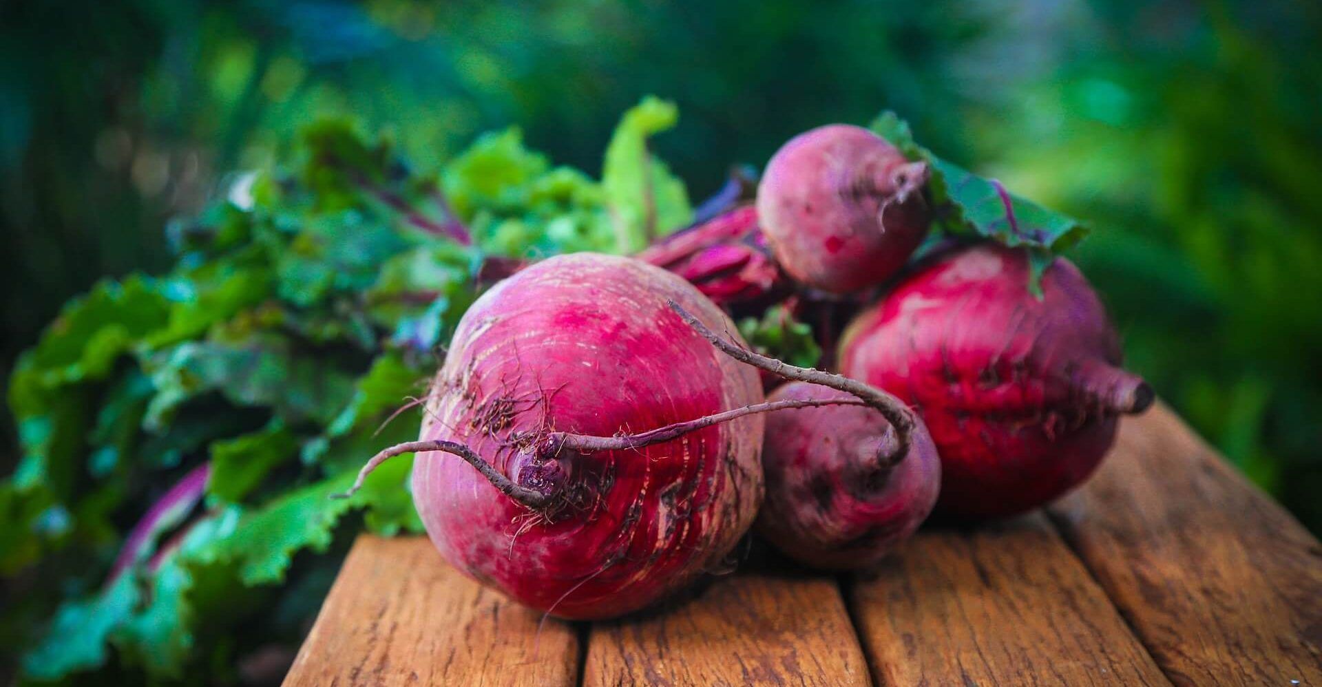 Fresh beets on wood bench