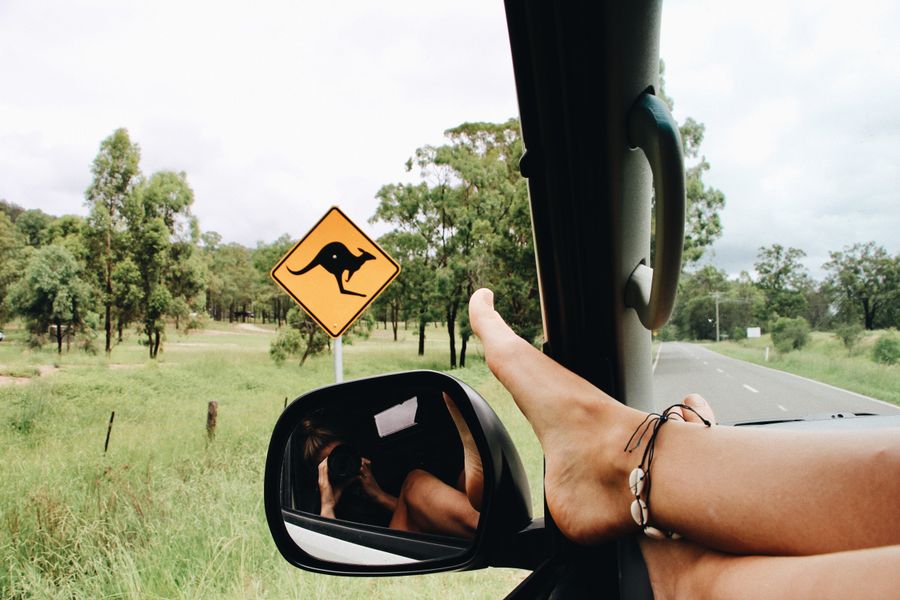 Person relaxing with their feet on the dash in a campervan.