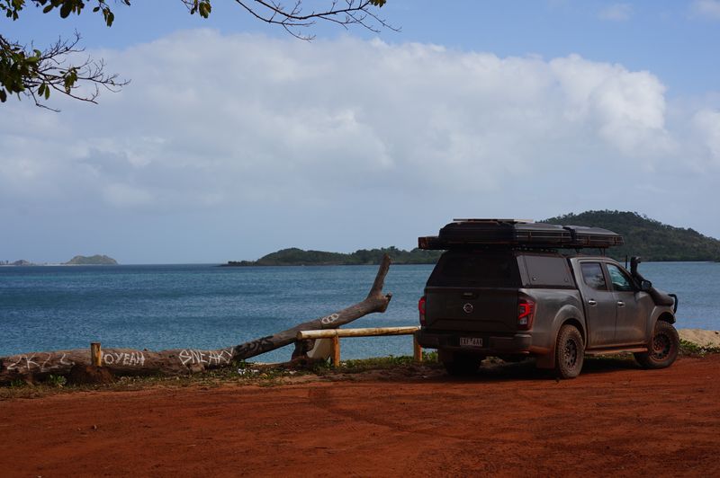 4WD camper with rooftop tents on red australia dirt by the oceanside