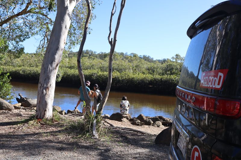 Campervan camping by a creek