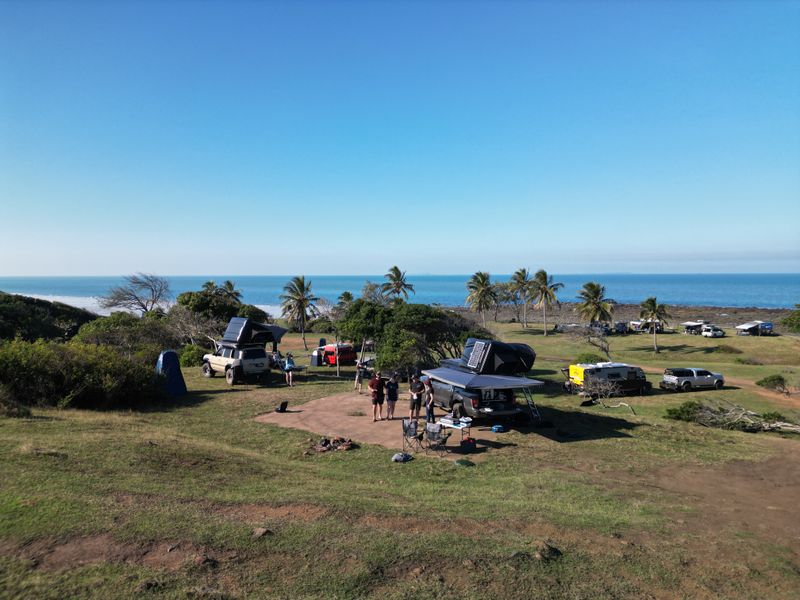 4x4 Camp site with palm trees and ocean in background