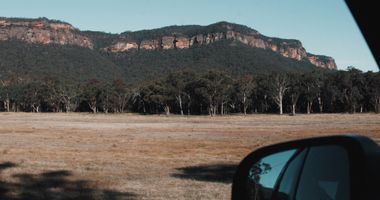 Photo of the blue mountains taken from the window of a car