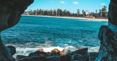 Photo of beach from the inside of a small cave