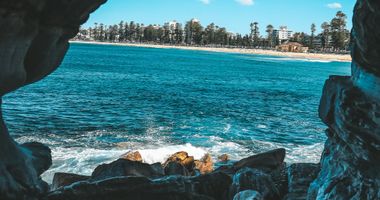 Photo of beach from the inside of a small cave