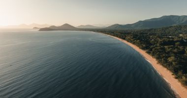 Palm Cove beach with palm trees and ocean