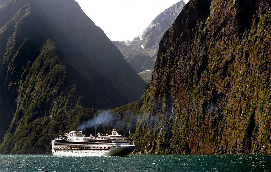 Cruise ship near scenic mountain landscape