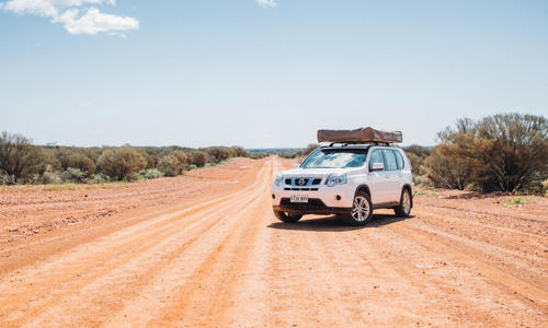 4WD camper on a long stretch of a outback dirt road