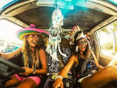 Friends laughing inside the Mystery Machine camper
