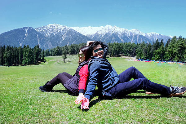 Couples sit on hills