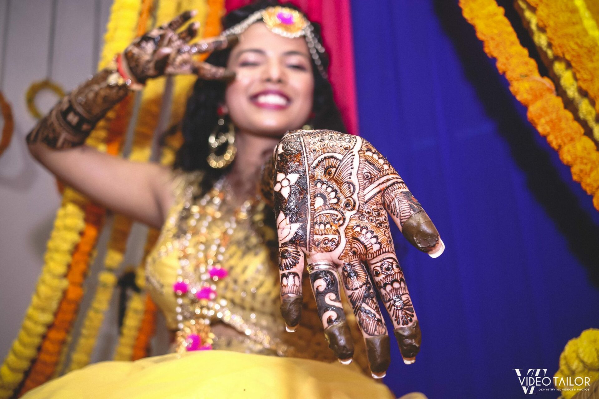 Bride Posing Back Hand Floral Mehndi Design with Diamond Jewellery